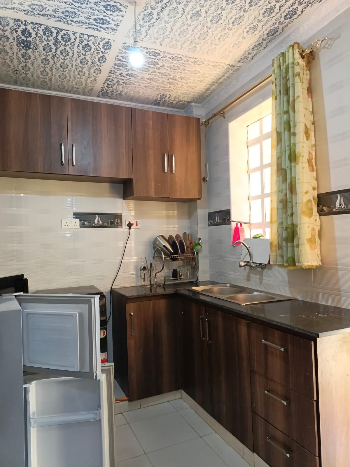 Dark cabinets and patterned ceiling