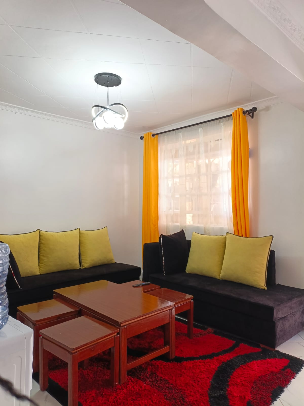 Black sofa with mustard cushions